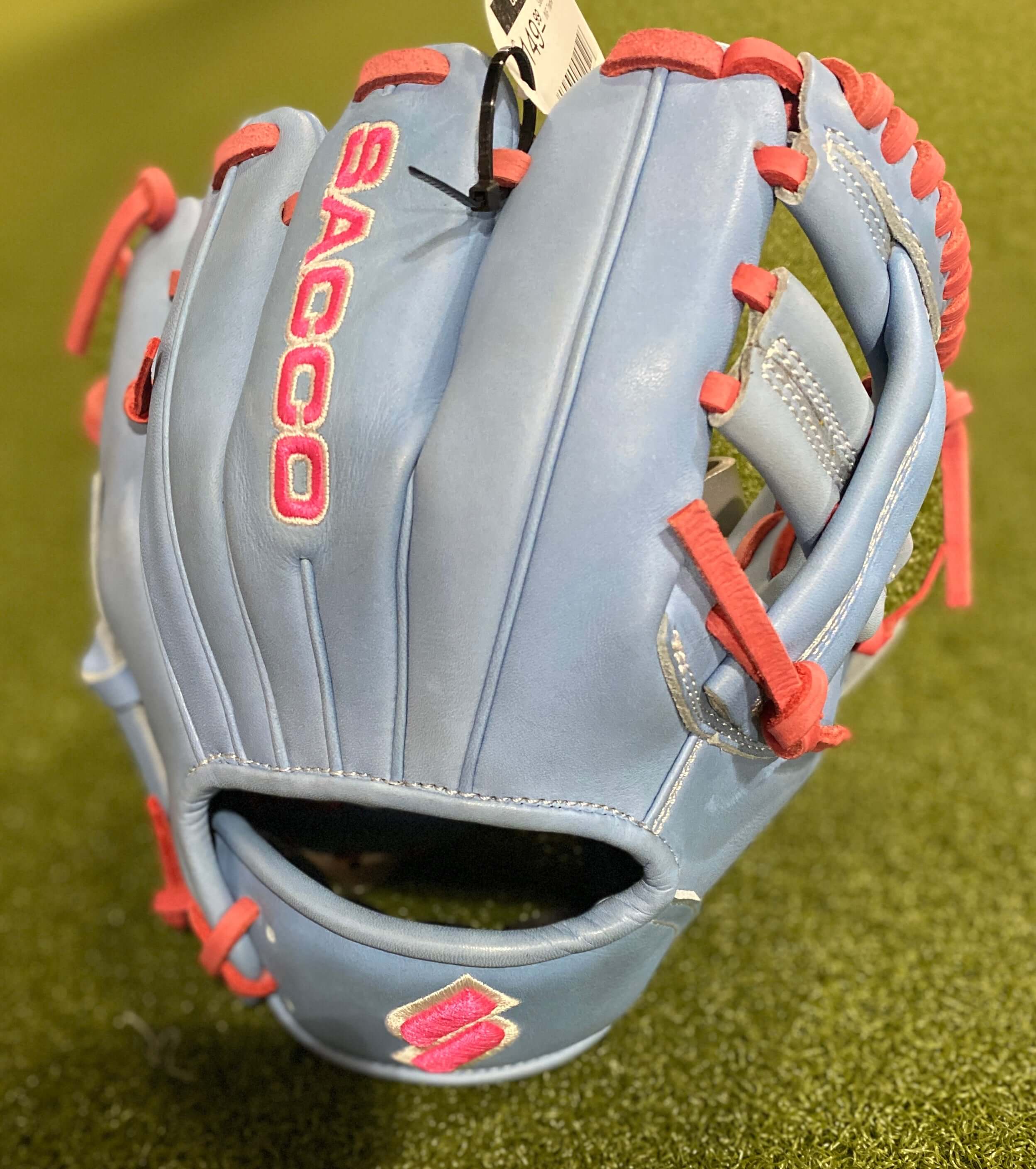 Sacco light blue baseball glove with pink accents, designed for comfort and performance in youth sports.