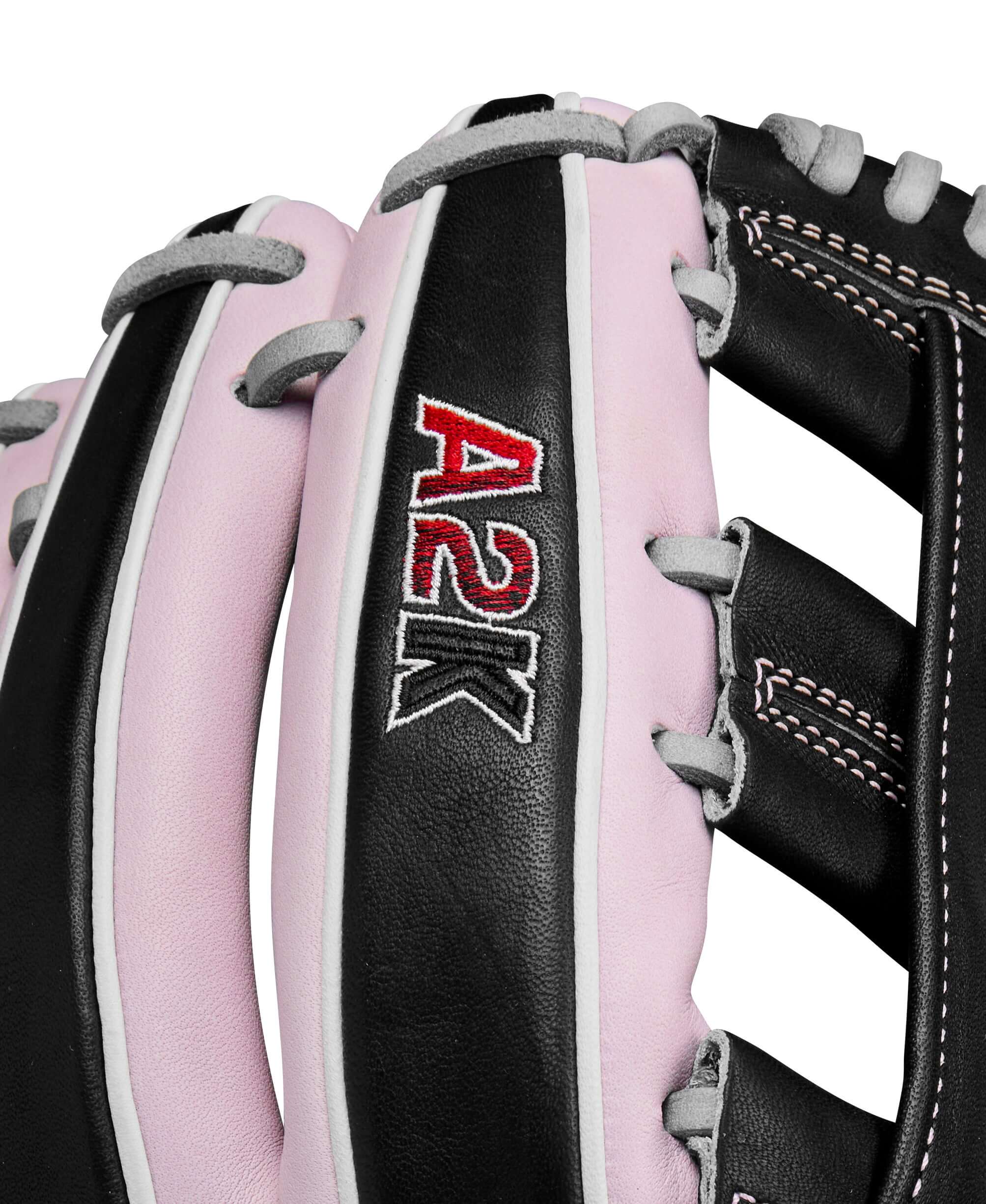 Close-up of A2K logo on fingers with quality craftsmanship on Black leather.