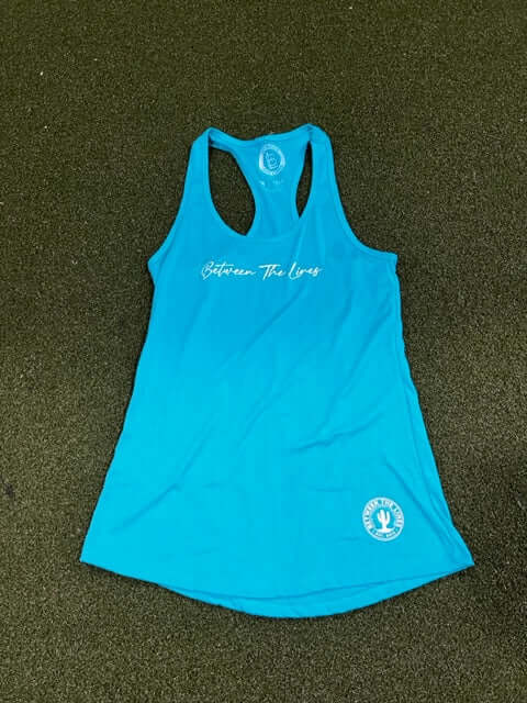 Between The Lines Racerback Women's T-Shirt in turquoise, featuring a trendy design on a green background.