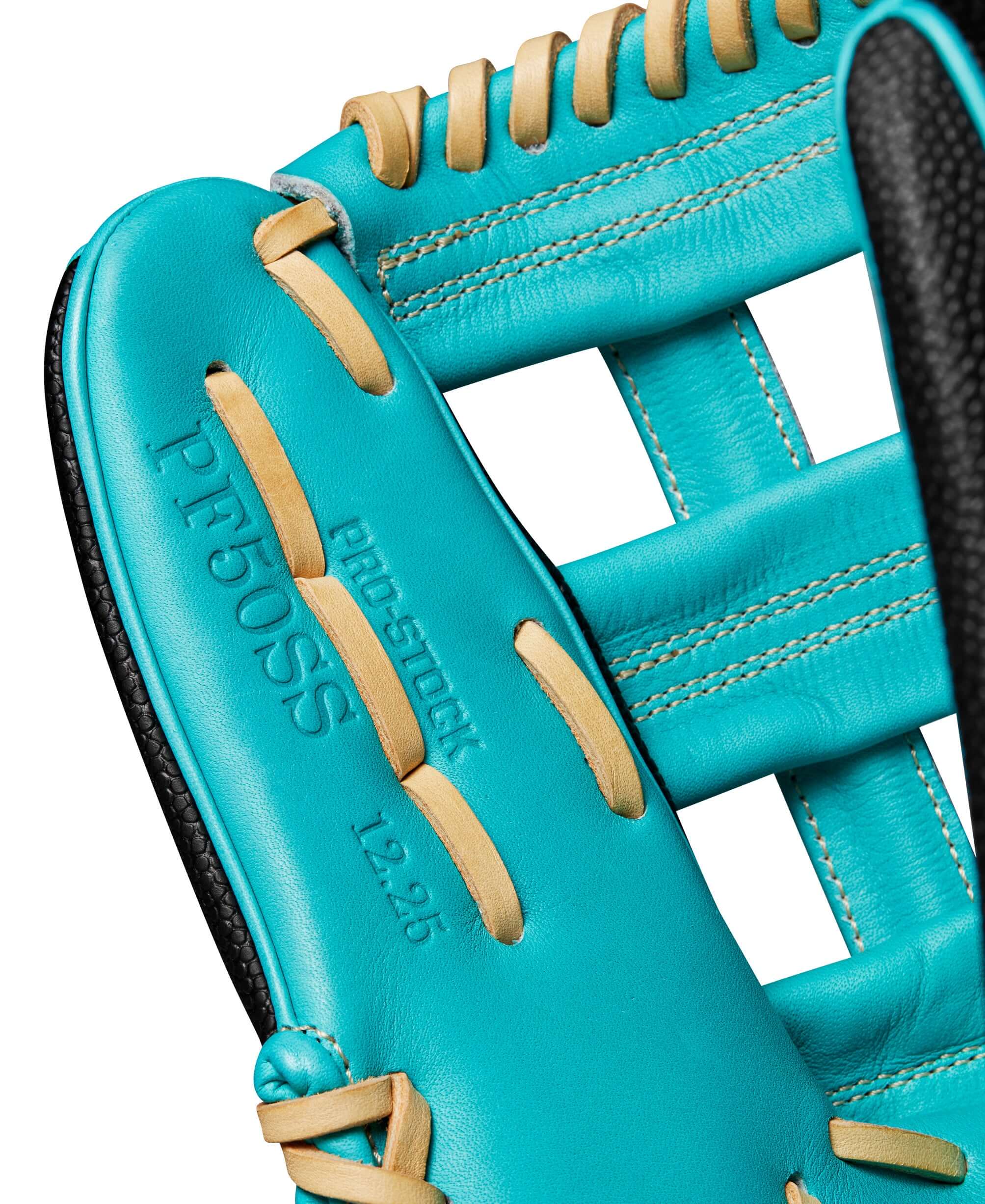 Close-up of the Wilson A2000 PF50SS outfield glove's interior with turquoise leather and Pro Stock markings.