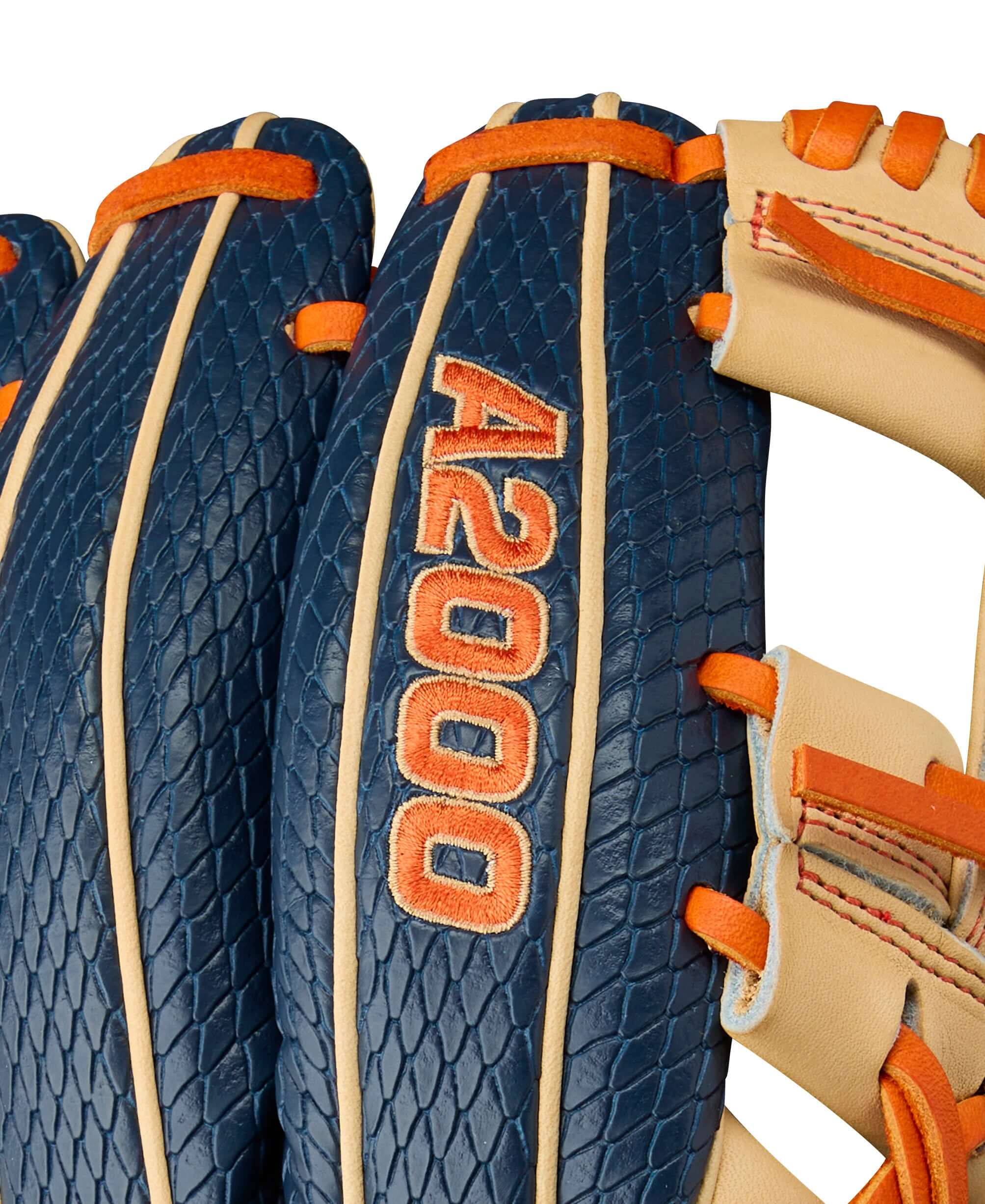 Close-up of Wilson A2000 Jose Altuve glove, showcasing navy and orange design and Pro Stock leather texture.