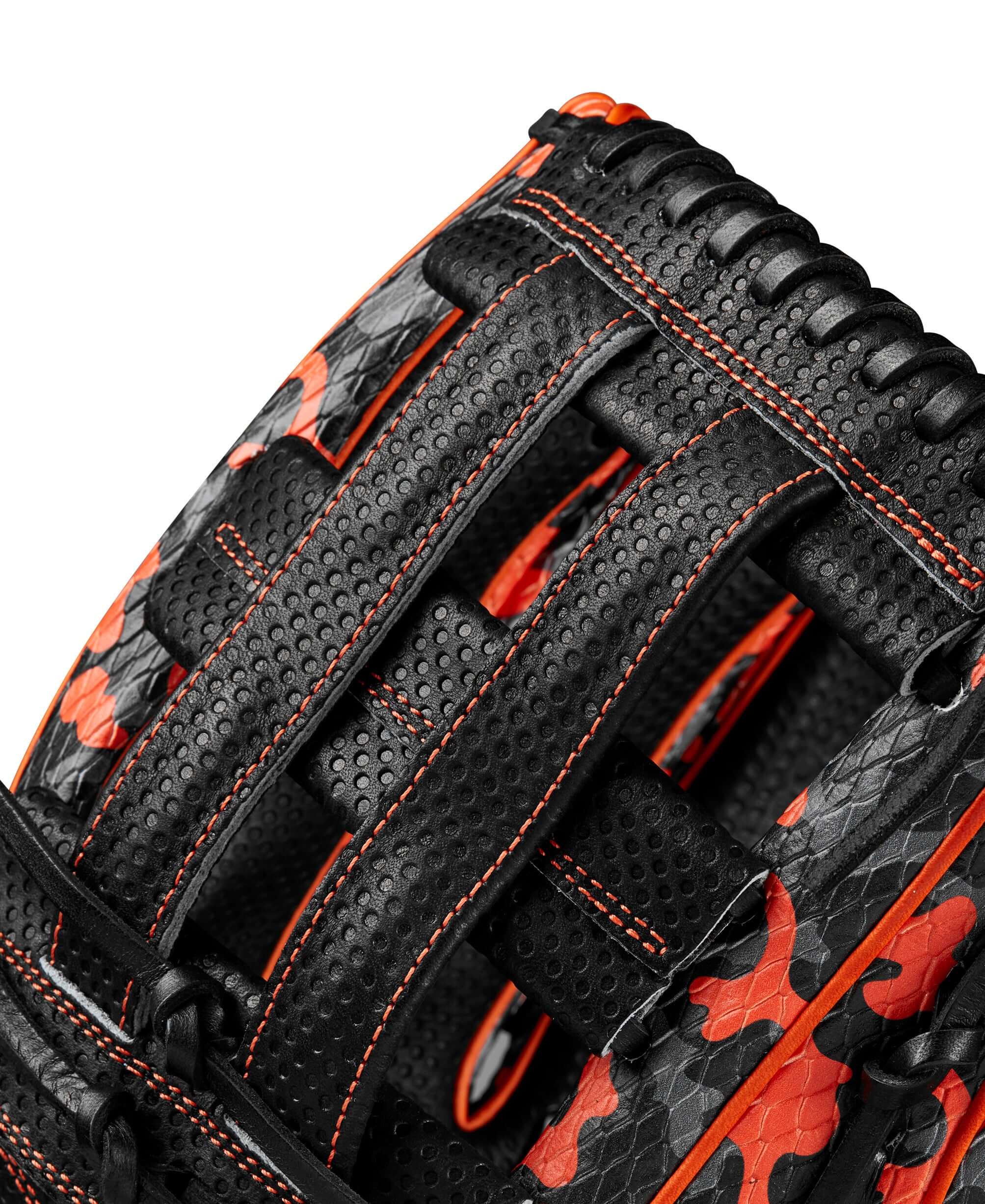 Close-up of Wilson A2000 1777 glove showing orange and black camouflage SuperSnakeSkin™ and dual post web design.