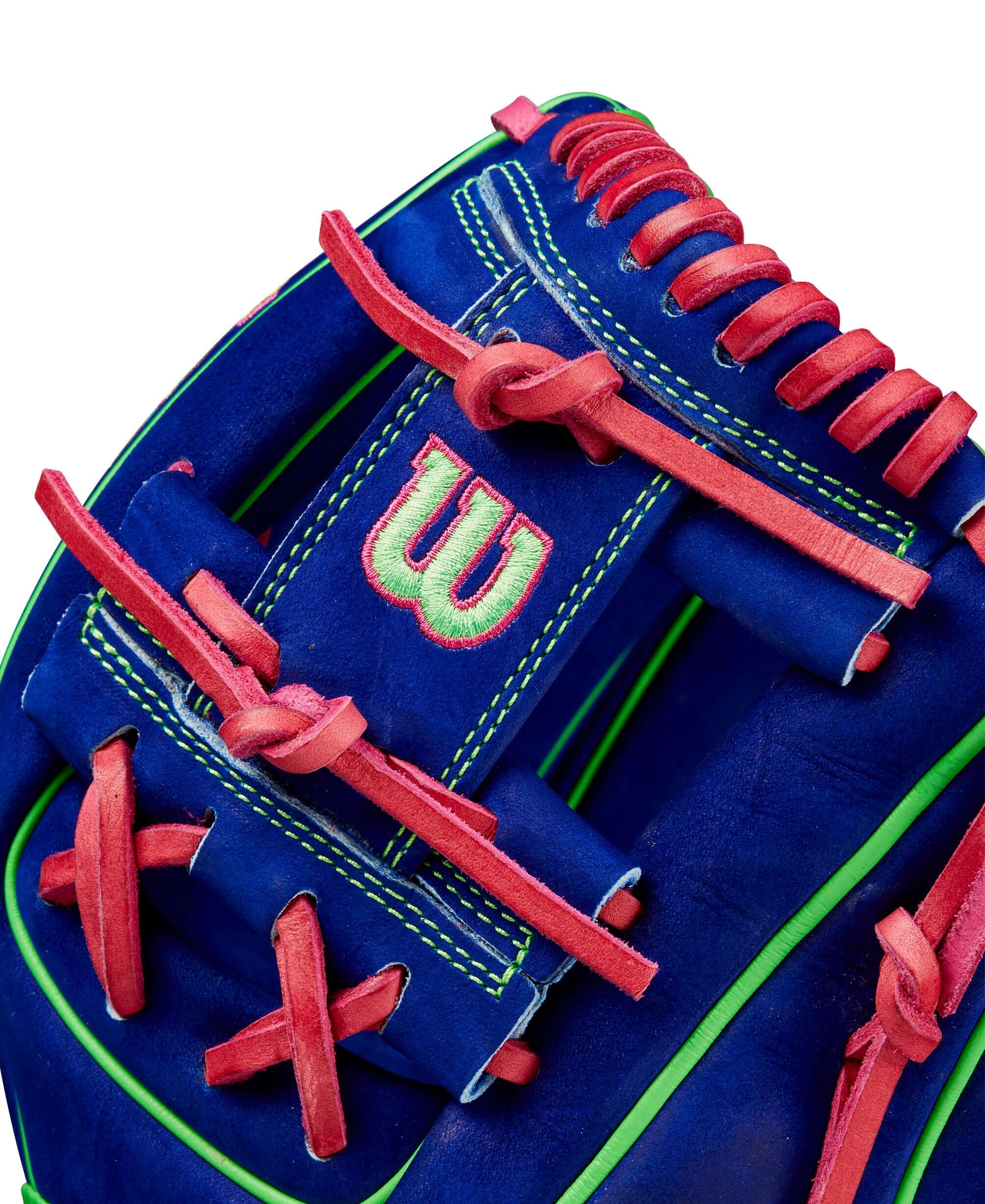 Close-up of Wilson A2000 11.5" glove featuring blue velvet leather with neon green and flamingo pink accents.
