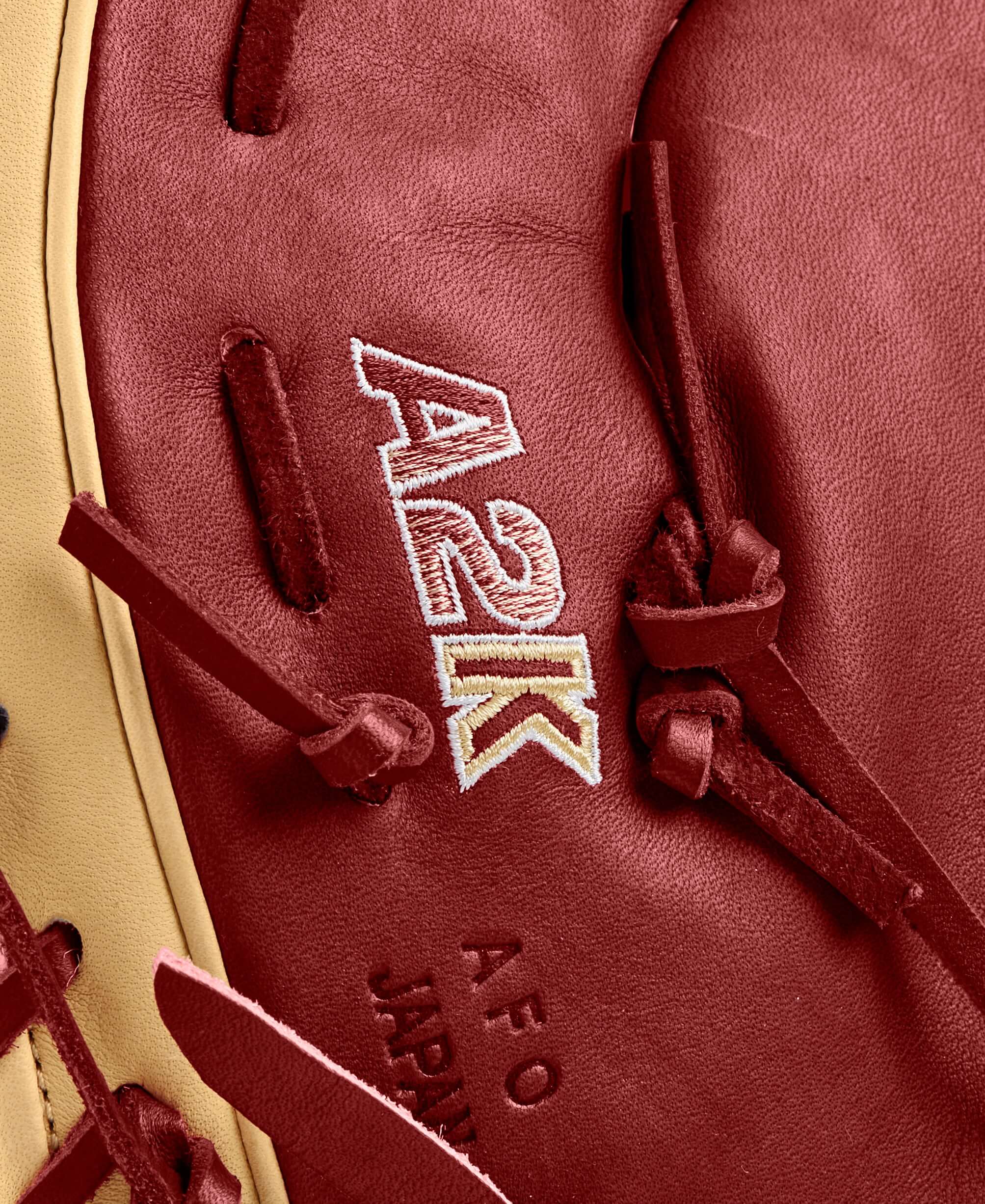 Close-up of the Wilson A2K first base mitt with red leather and detailed stitching, highlighting craftsmanship and quality.
