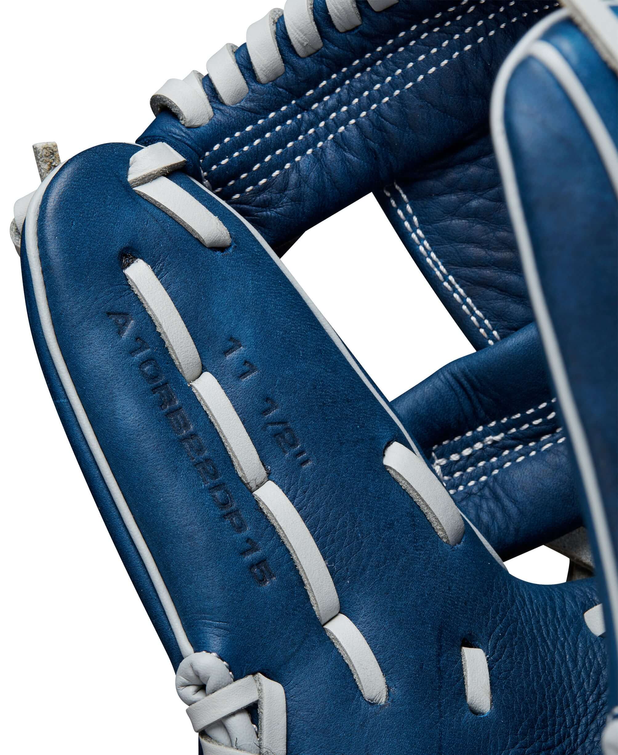 Close-up of the Wilson 2024 A1000 DP15 infield baseball glove showing Navy Full Grain Leather details and stitching.