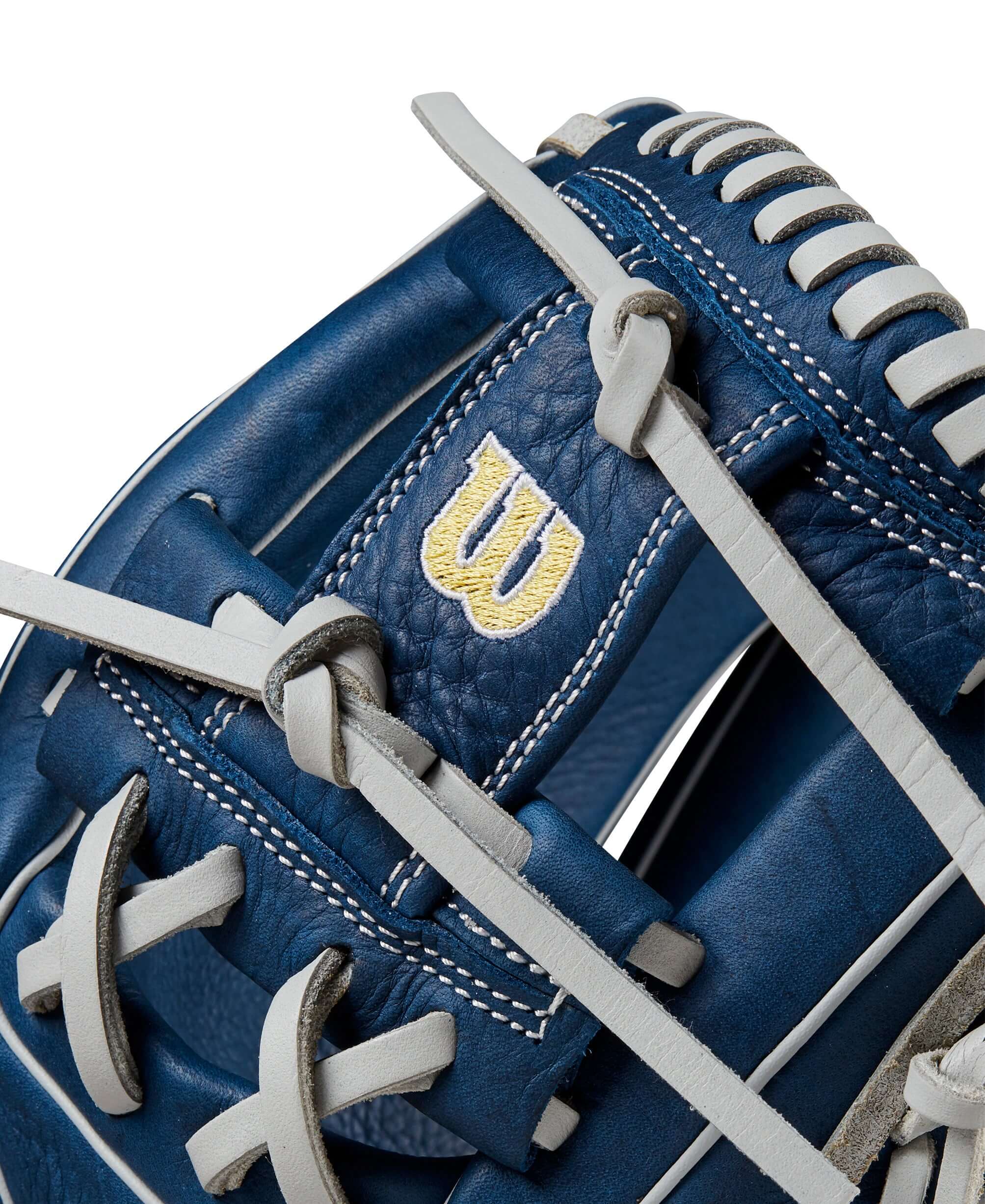 Close-up of Wilson 2024 A1000 DP15 baseball glove detailing, featuring navy leather and signature logo.