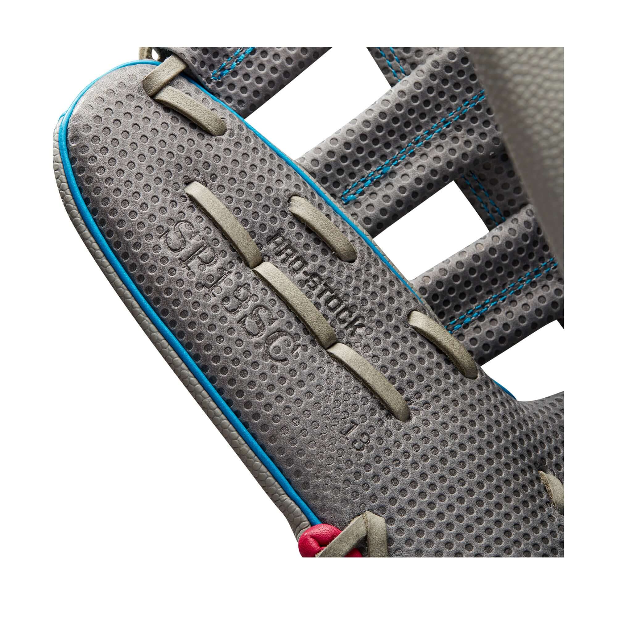 Close-up of Wilson A2000 SCSP13SS slowpitch softball glove showcasing Spin Control Technology and Pro Stock leather details.