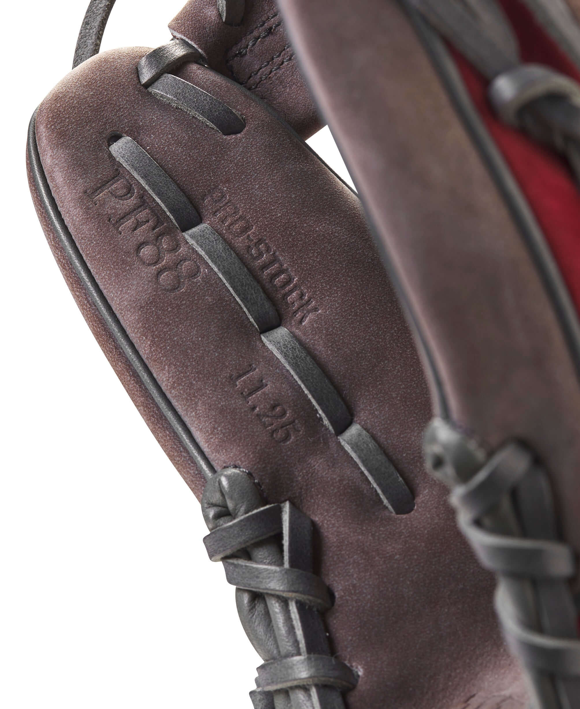 Close-up of Wilson A2000 PF88 glove detailing, showing buffed leather and Pedroia Fit label. Ideal for young players.