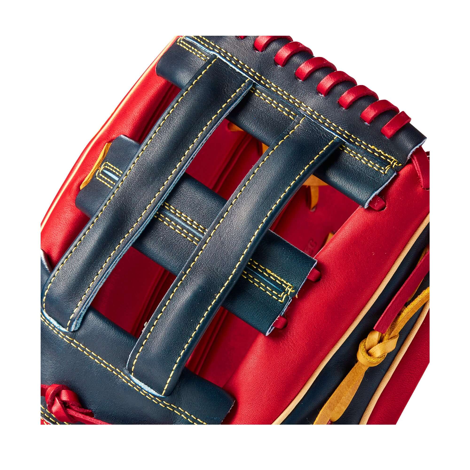 Close-up of the dual post web and stitching on the Wilson A2K Juan Soto baseball glove in red and black leather.