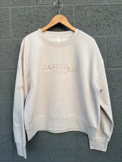Light beige Baseball Mom Crew sweatshirt on a hanger, featuring a classic crew neckline and long sleeves.