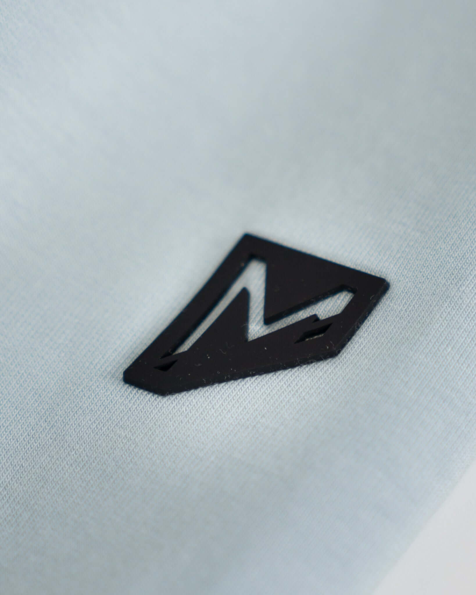 Close-up of Bauer logo on lightweight fabric, showcasing athletic style and quality.