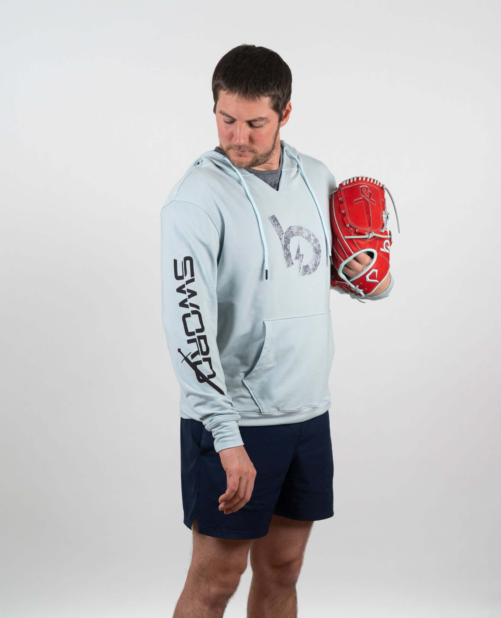 Man wearing a light blue hoodie with a glove, showcasing modern athletic style and comfort.