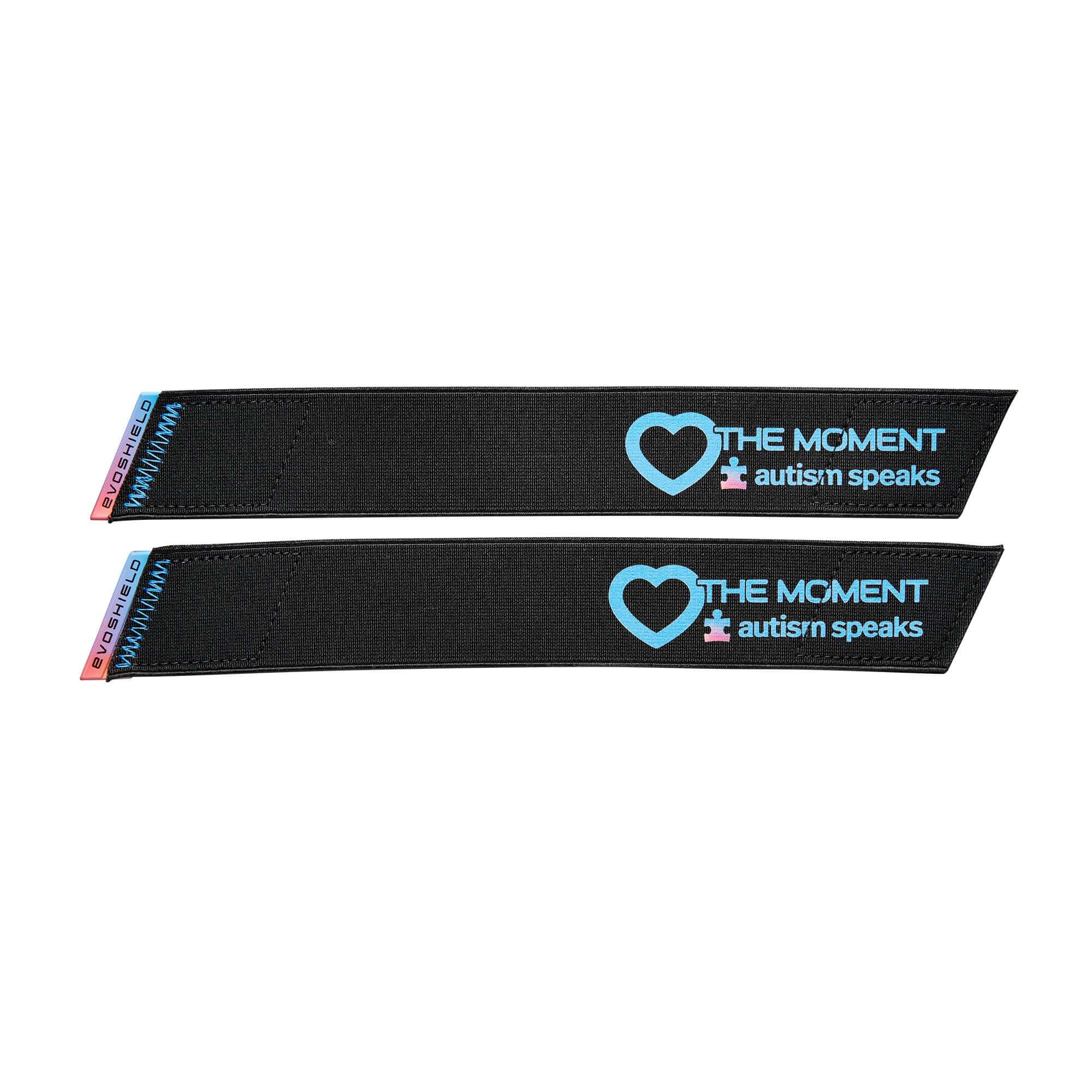Black straps featuring "The Moment" and Autism Speaks logo for Evoshield elbow guard, promoting awareness and support.