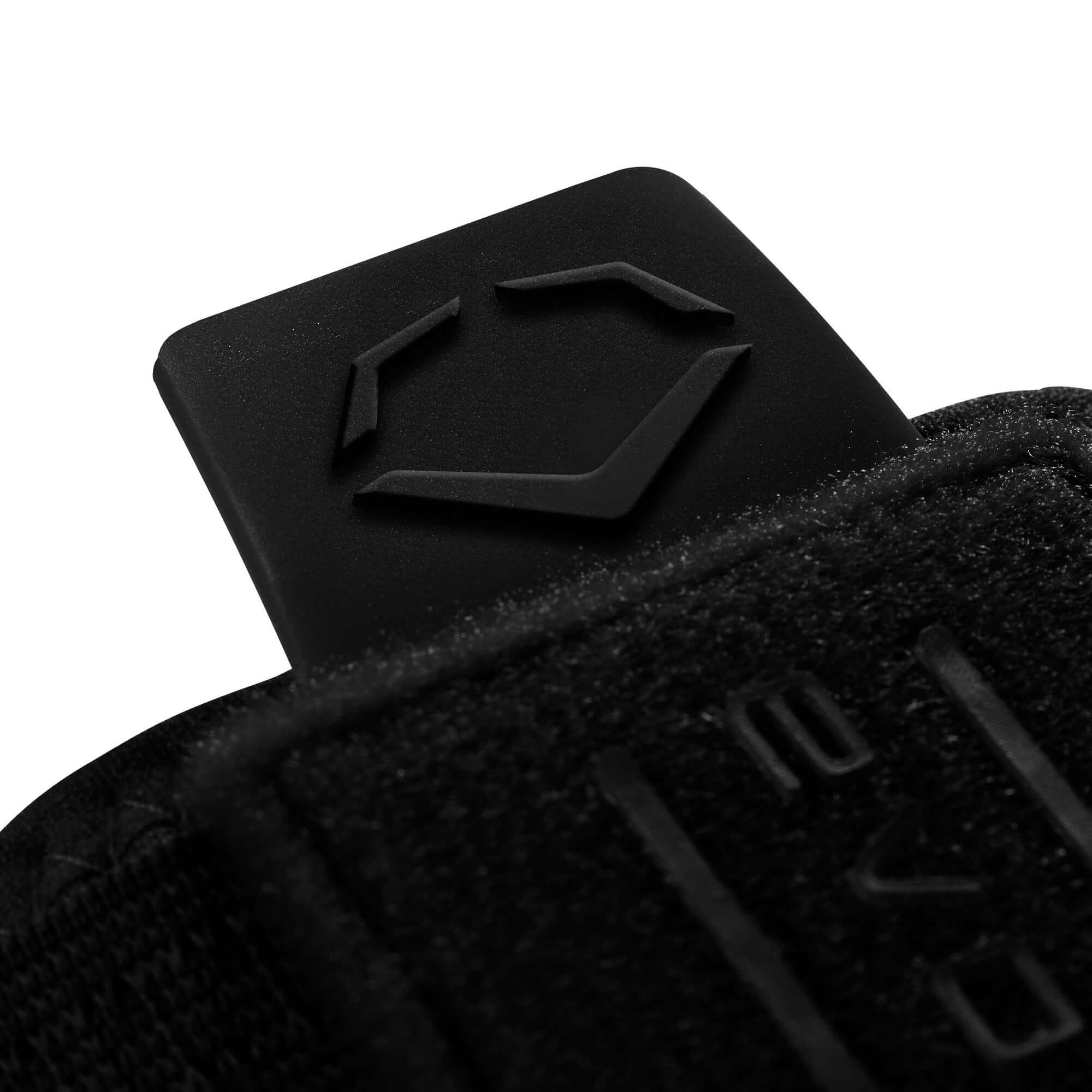 Close-up of the black EvoShield logo on the strap of the Sliding Mitt 2.0, highlighting its design features.