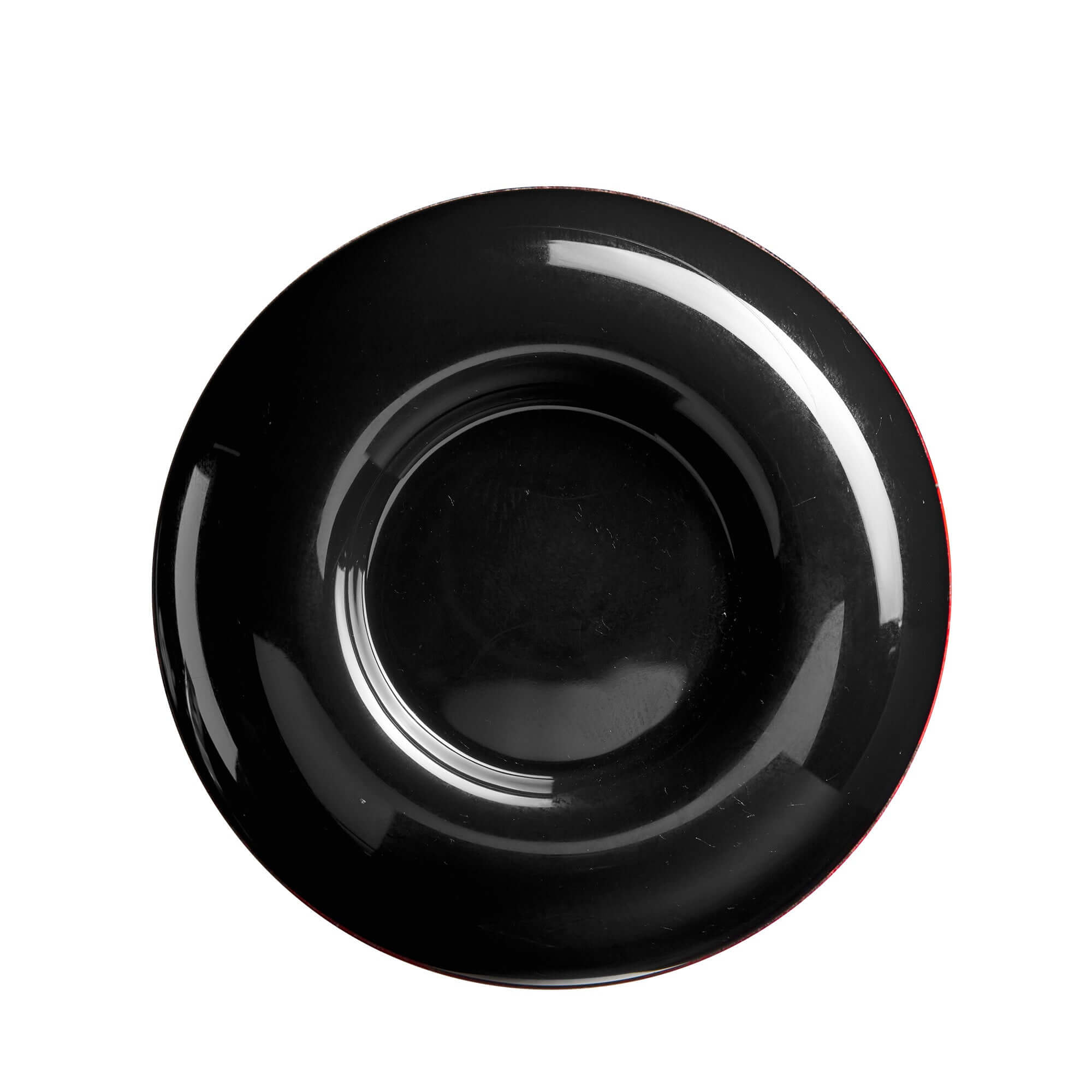 Top view of a glossy black ceramic plate with a subtle red edge.