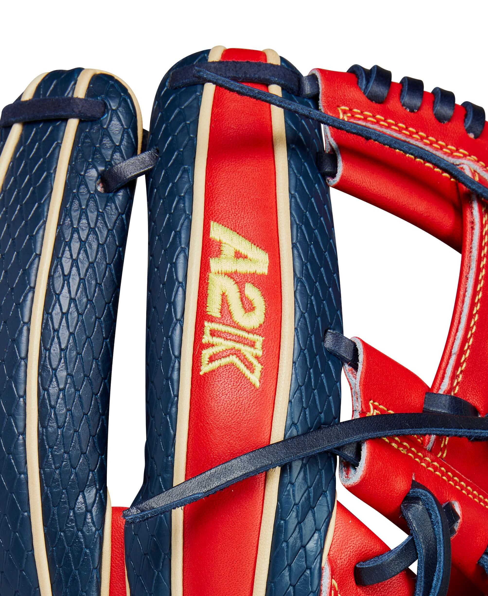 Close-up of Wilson 2024 A2K glove featuring vibrant navy and red design with A2K logo and SuperSnakeSkin™ texture.