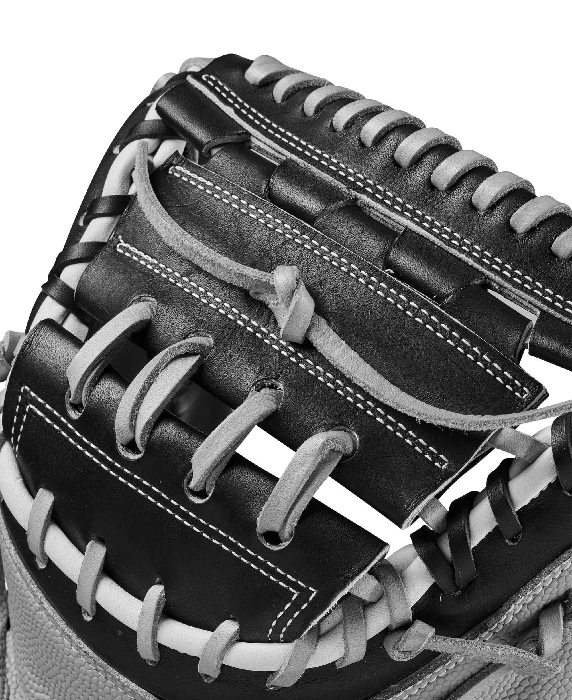 Close-up of Wilson A2000 FPCM34SS catcher's mitt, showcasing black and grey leather and detailed stitching.