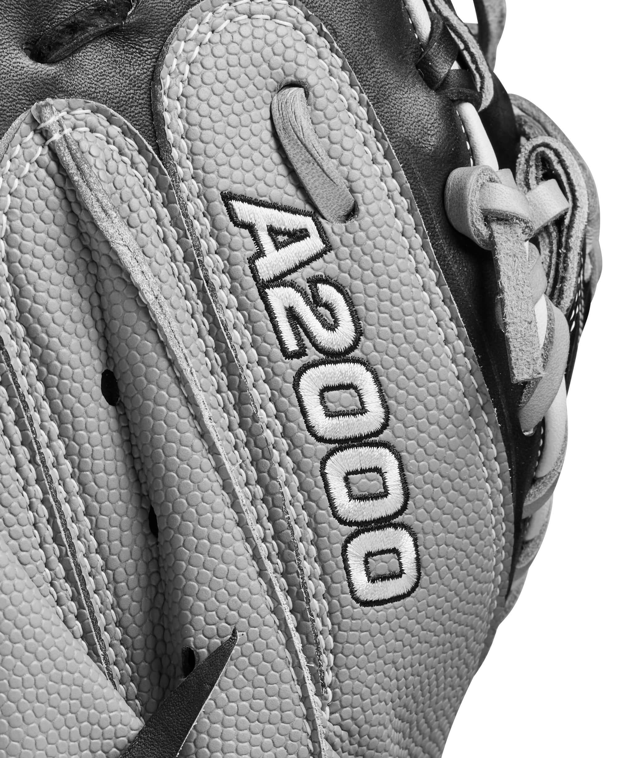 Close-up of Wilson A2000 fastpitch catcher's mitt with textured surface and branding in black and grey colors.