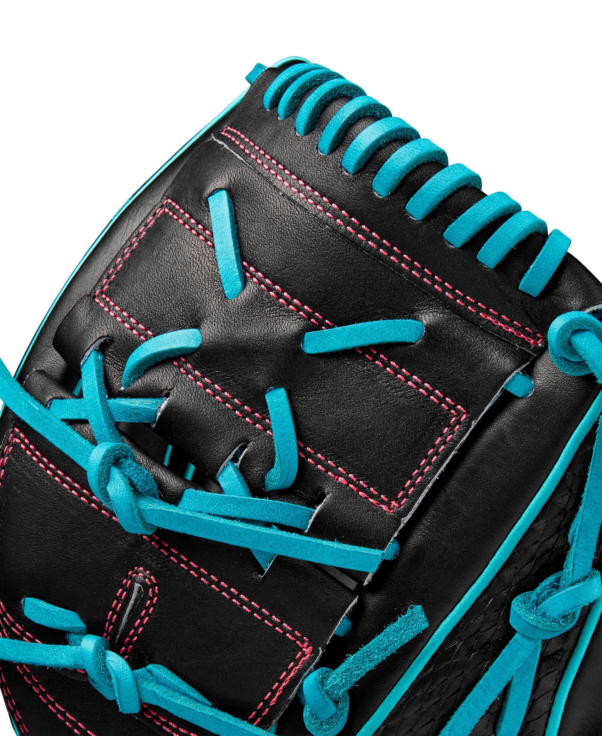 Close-up of Wilson A2000 B2 pitcher's glove in black and teal with detailed stitching and lacing.