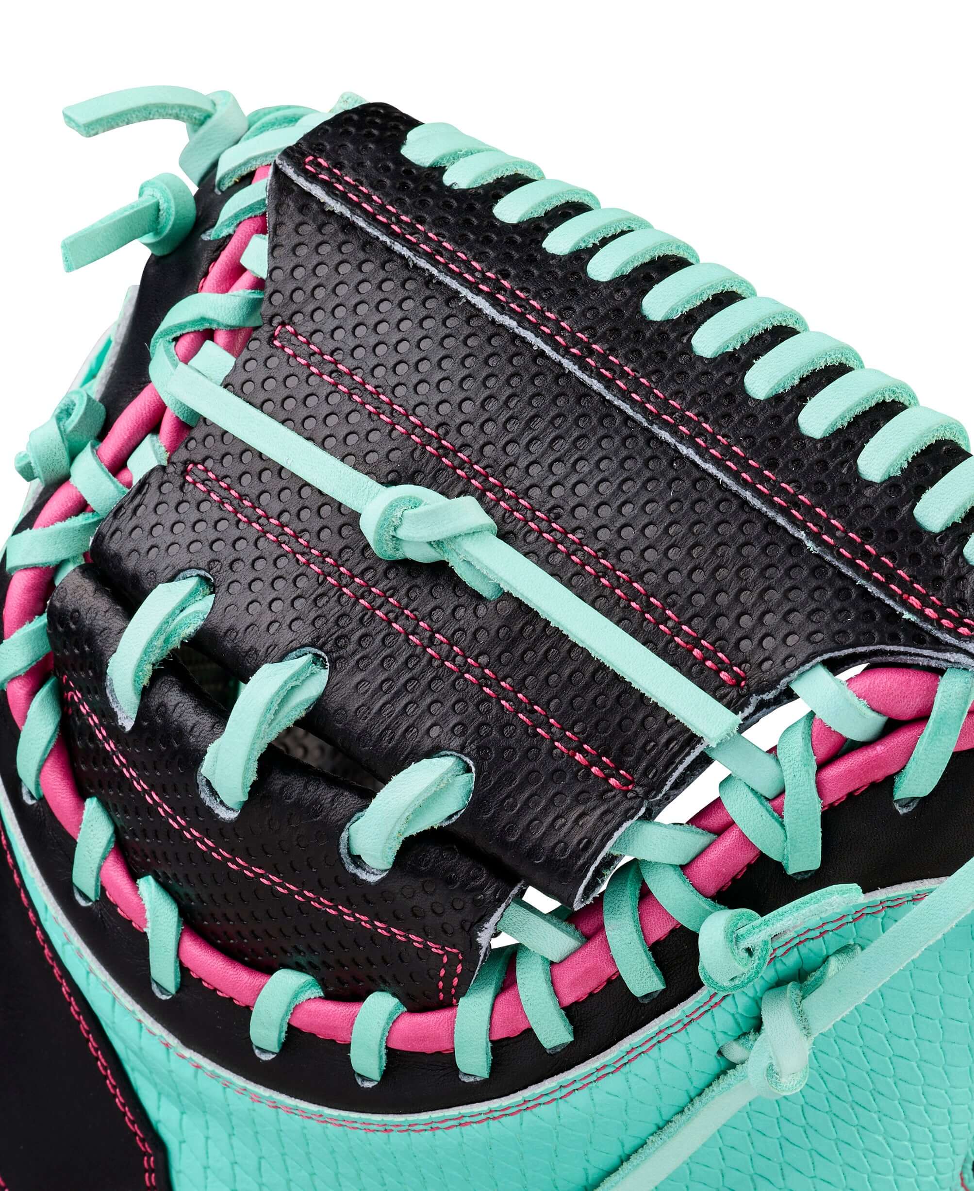 Web detail of Wilson Spring 2026 A2000 SCM23SS 33.5” Baseball Catcher’s Mitt, featuring black webbing, pink lacing, and teal trim.