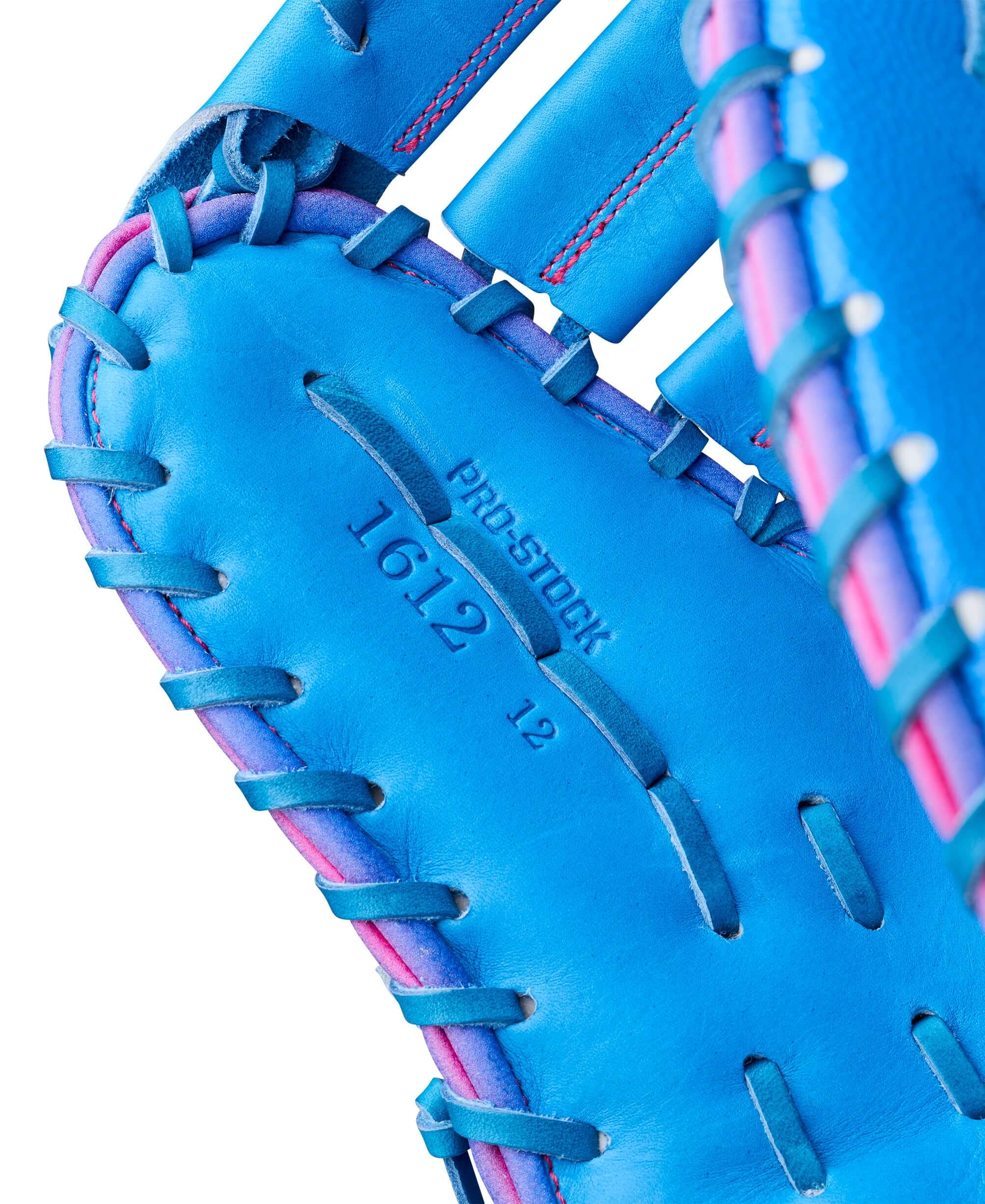 Palm view of Wilson 2026 Love the Moment A2000 1612 12” Baseball First Base Mitt, showing blue leather and pink lacing.