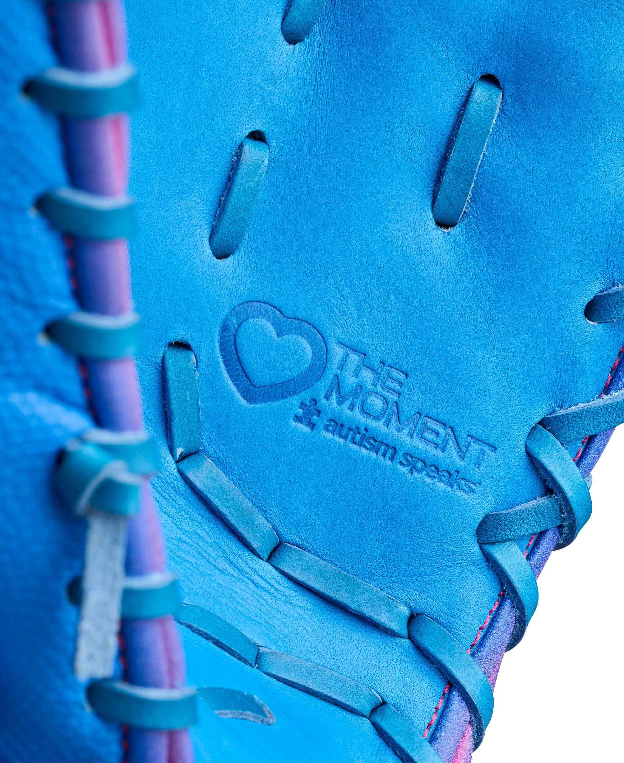 Close-up of Wilson 2026 Love the Moment A2000 1612 glove web detail, showing blue leather and pink lacing.