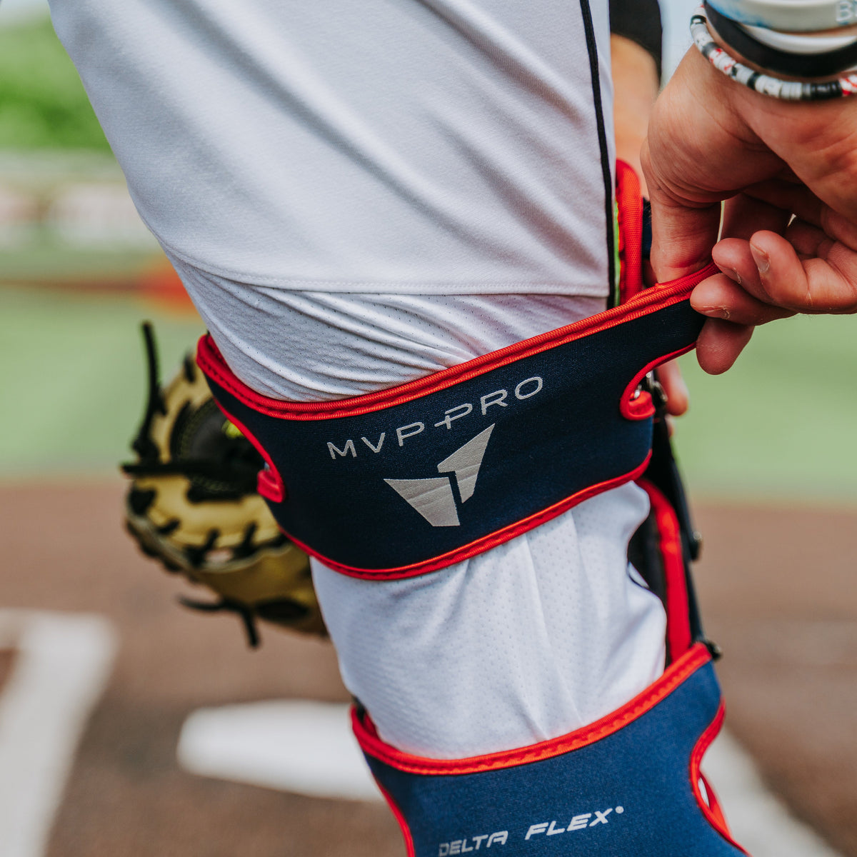 All-Star MVP-Pro leg guard Delta Flex harness adjustment in navy/scarlet