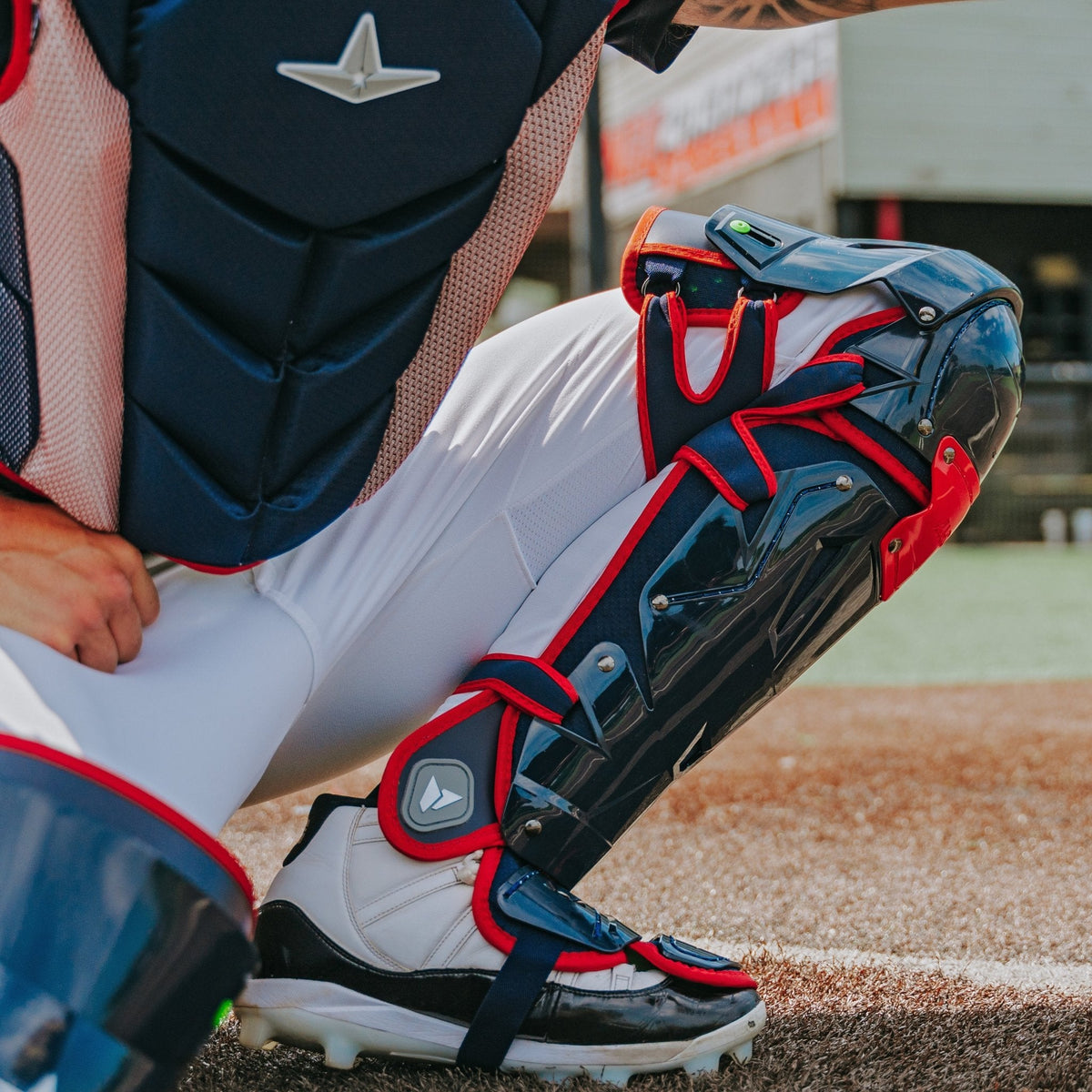 All-Star MVP-Pro leg guard liner and harness detail in navy/scarlet