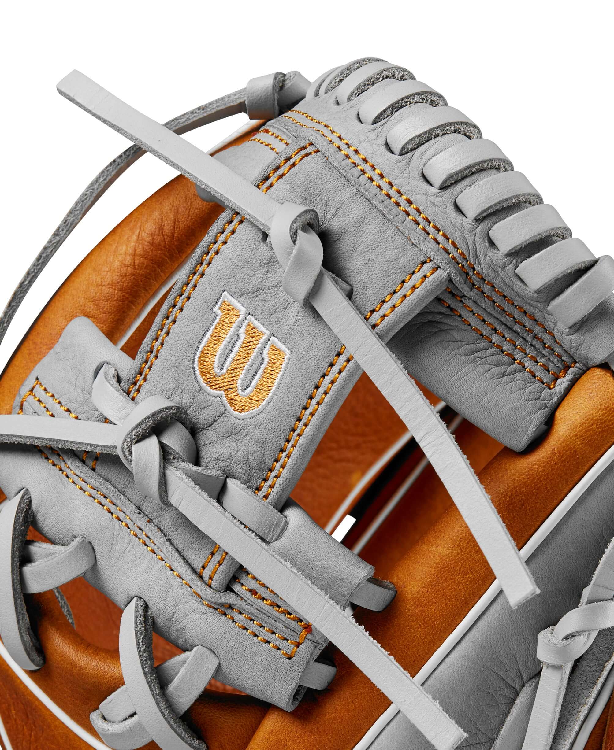 Close-up of Wilson 2024 A1000 PF11 infield baseball glove in saddle tan and silver with intricate lacing and logo detail.