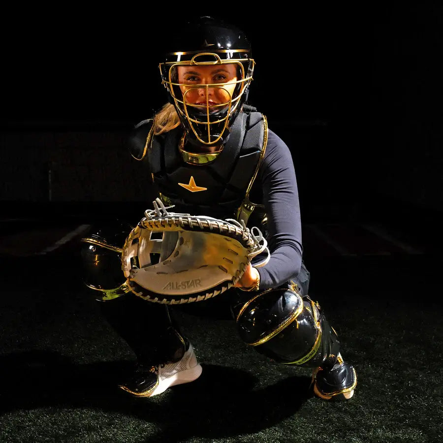 Catcher in All-Star PHX™ Diamond Series Softball Catcher's Kit | Black/Gold, crouched with glove visible. Front view.