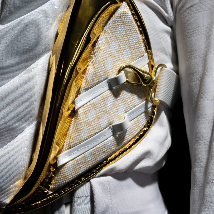Close-up of gold and white strap detail on All-Star MVP Pro PHX™ Diamond Series Softball Catcher's Kit | White/Gold (Small).
