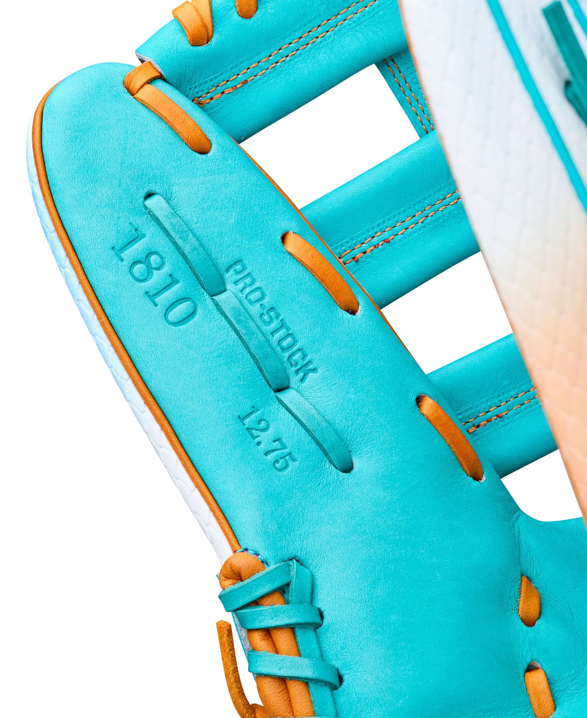 Close-up of Wilson A2000 1810 Northern Lights 12.75" outfield baseball glove, showcasing vibrant turquoise leather and stitching.