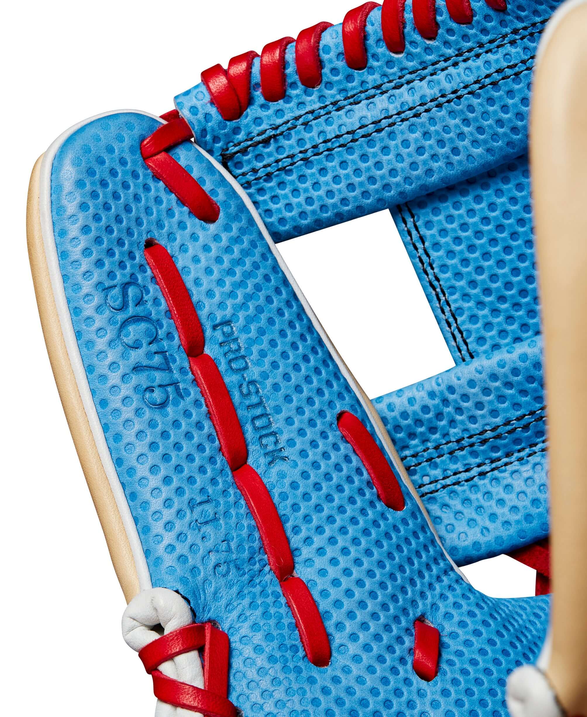 Close-up of the Wilson A2000 SC1975 infield glove, showcasing the Sky Blue Pro Stock leather and red lacing details.