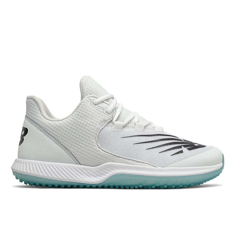 New Balance FuelCell T4040v6 baseball turf shoes in white and black, featuring a synthetic mesh upper and nubby rubber outsole.