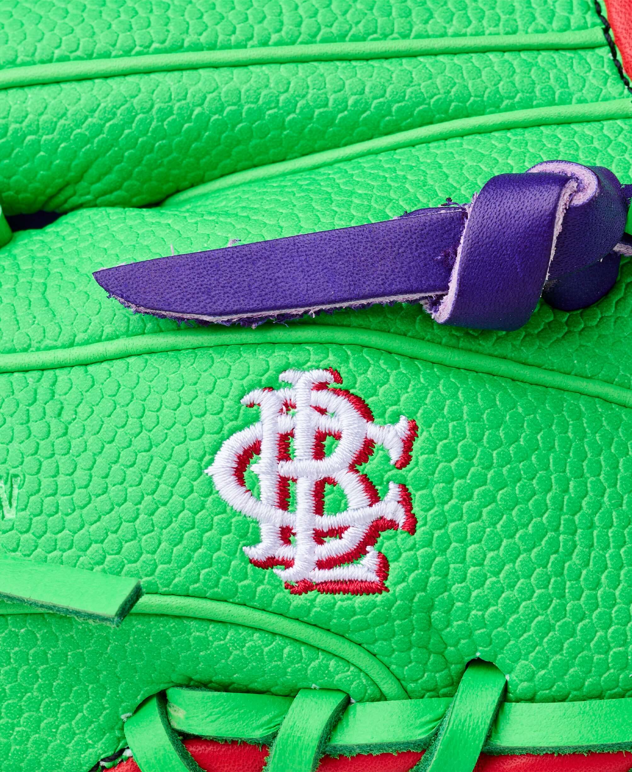 Close-up of Wilson Swingin’ Sour Apple A2000 1786 glove with purple lacing and embroidered logo