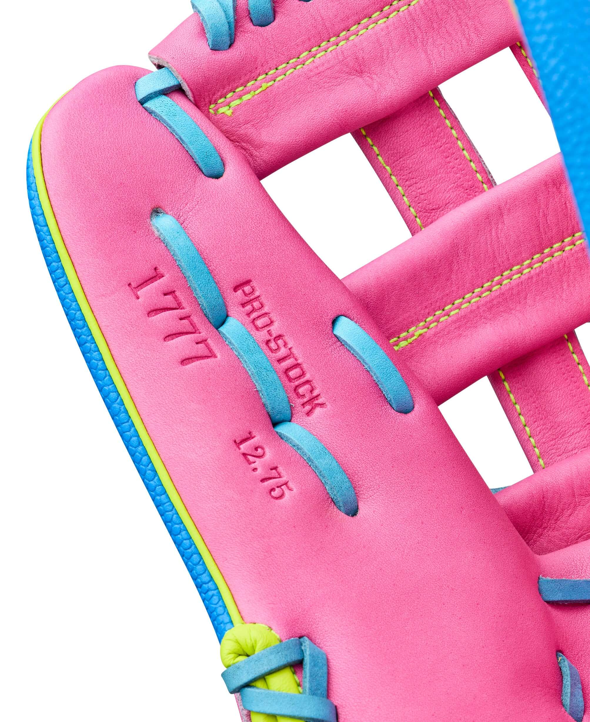 Close-up of Wilson 2026 Love the Moment A2000 1777 showing pink leather, blue lacing, and "1777 Pro Stock 12.75" detail.